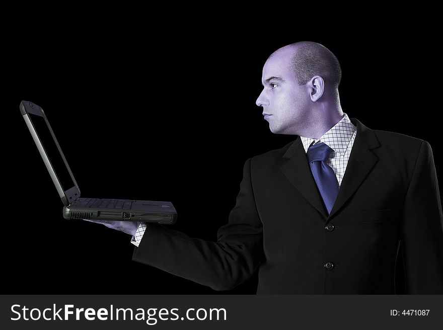 A Businessman with laptop computer on black background