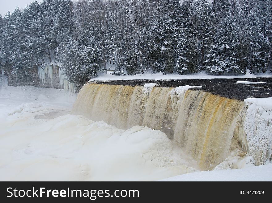 A waterfall partially frozen in the wintertime. A waterfall partially frozen in the wintertime.