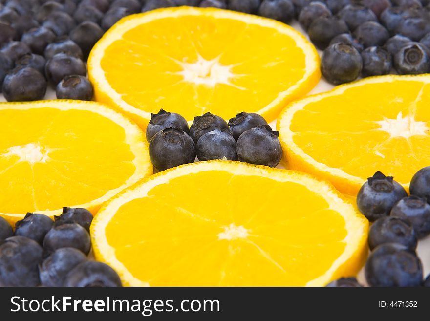 Blueberries and orange slices isolated on a white background