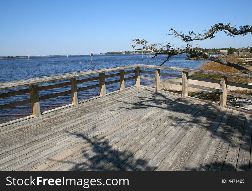 Large wooden deck and tree at shore. Large wooden deck and tree at shore.