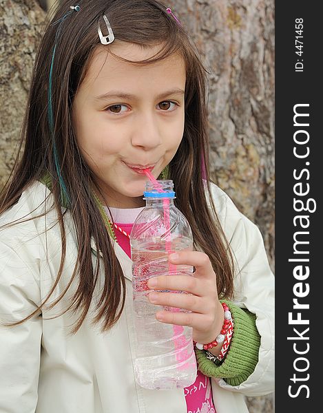 Little girl drinking mineral water. Little girl drinking mineral water