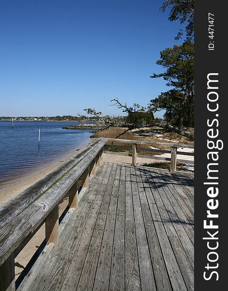 Large wooden deck and tree at shore. Large wooden deck and tree at shore.