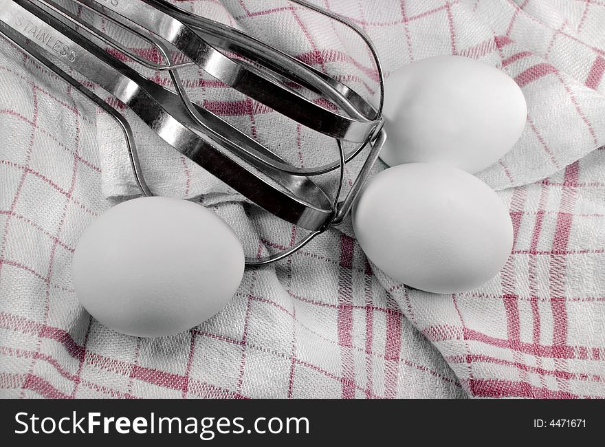 Eggs and Beater on a Dish Towel