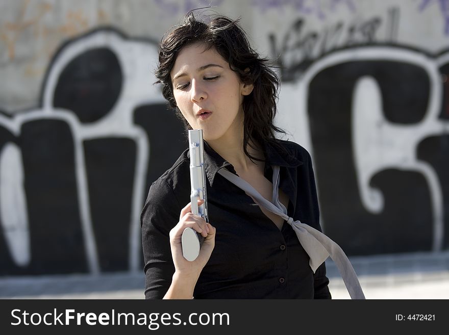 Woman blowing her gun after shooting. Woman blowing her gun after shooting