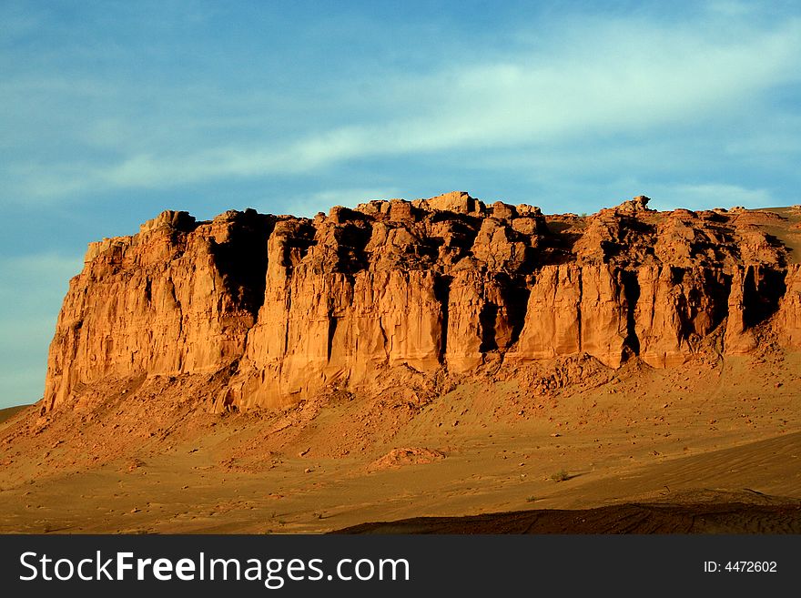 At gansu province in china, a grand golden rocky wall on the way to Dunhuang. At gansu province in china, a grand golden rocky wall on the way to Dunhuang.
