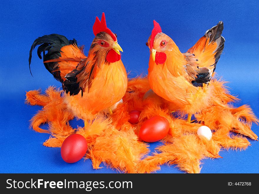 Hen, cock and eggs in easter decorations.