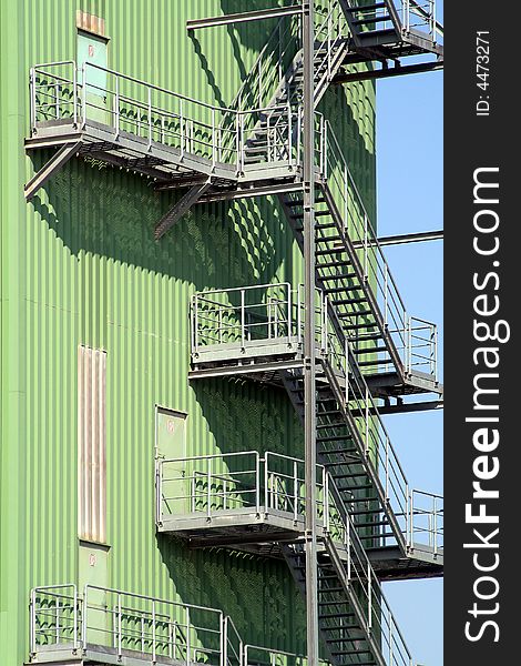 Green industrial building with stairs outside. Green industrial building with stairs outside