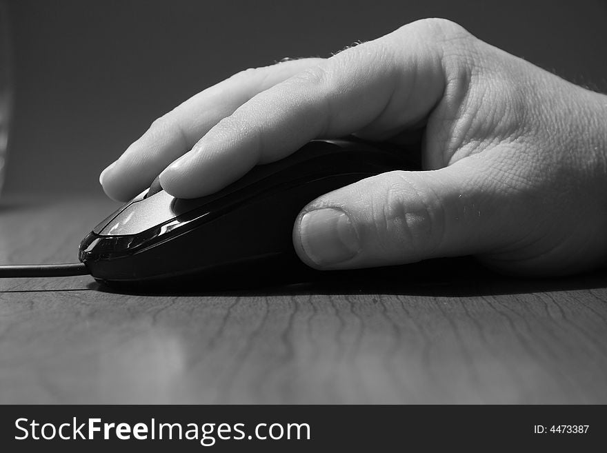 Black and White portrait of computer mouse and hand. Black and White portrait of computer mouse and hand