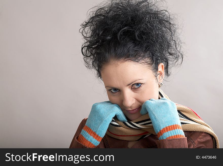 A blue-ayed girl in blue gloves and a scarf