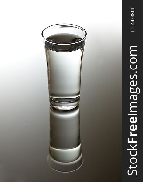 Glass of clear water with perfect reflection. Glass of clear water with perfect reflection.
