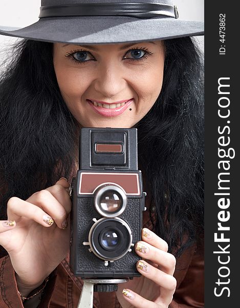 An image of woman with camera in studio. An image of woman with camera in studio