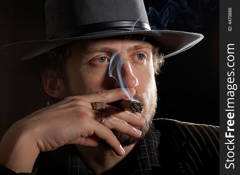 A Bearded Man With A Cigar