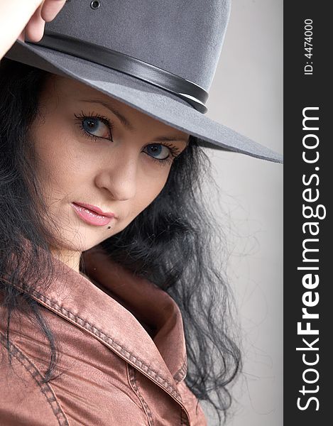 An image of a woman in felt hat. An image of a woman in felt hat