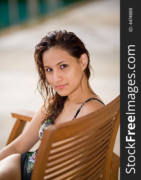 Woman relaxing by the pool