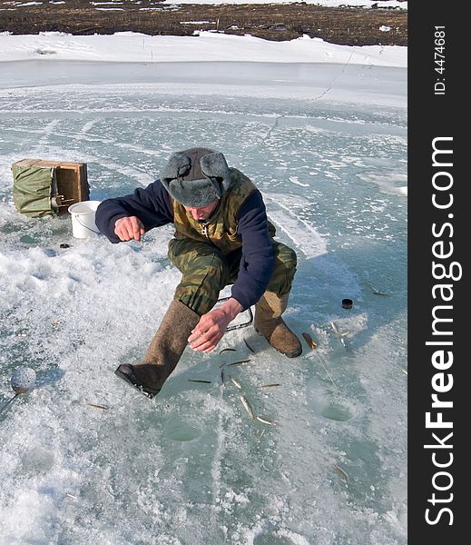 A winter fishing on river. People is fishing the smelt. Russian Far East, Primorye, Kievka river. A winter fishing on river. People is fishing the smelt. Russian Far East, Primorye, Kievka river.