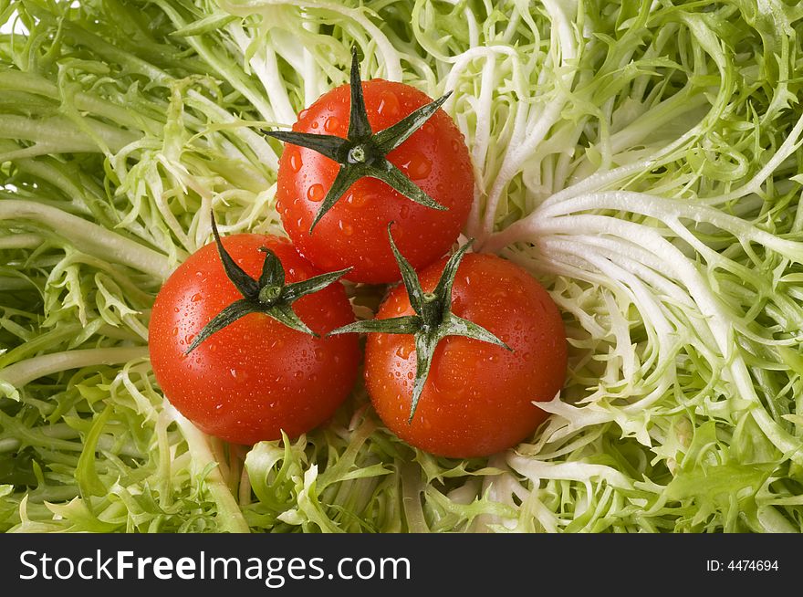 Red ripe tomatoes on green leaf lettuce close-up. Red ripe tomatoes on green leaf lettuce close-up