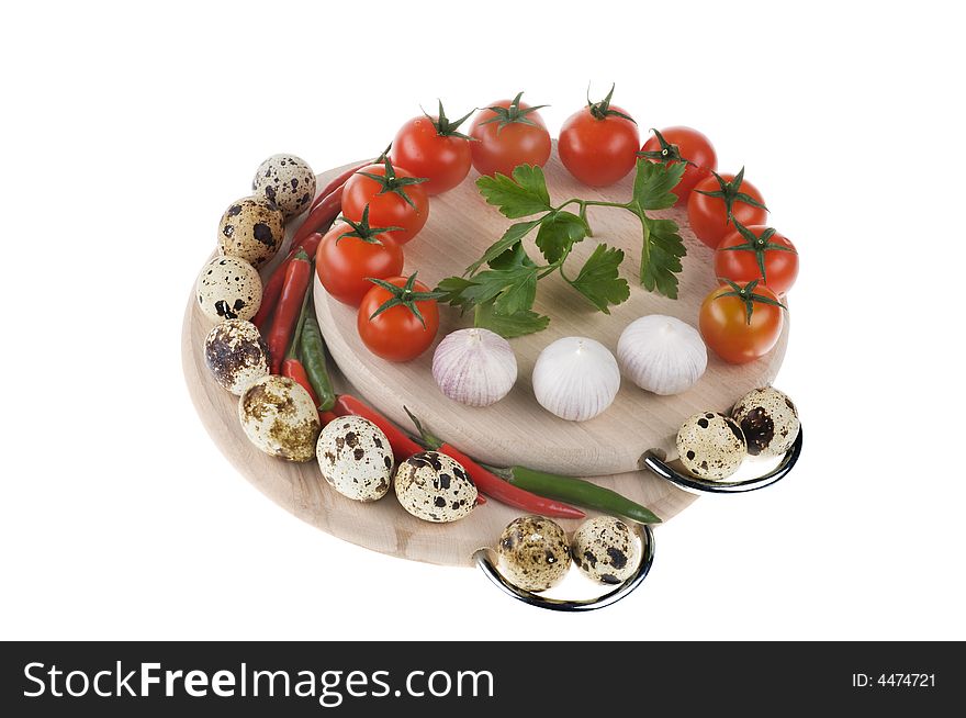 Tomatoes, eggs, garlic and parsley on wood board isolated over white background. Tomatoes, eggs, garlic and parsley on wood board isolated over white background