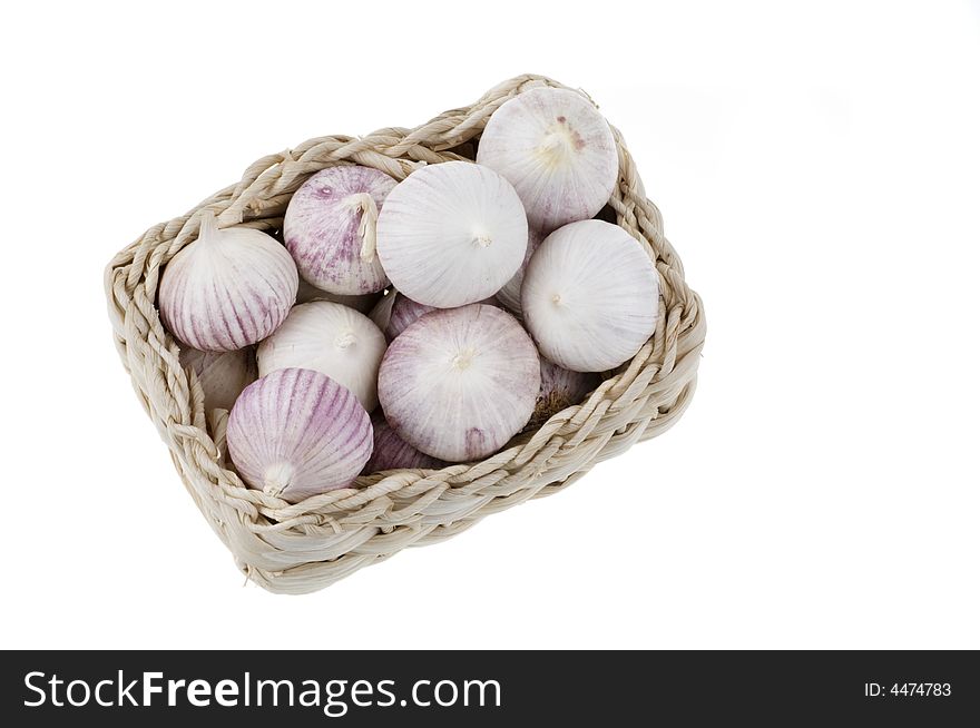 Garlic in a basket isolated on a white background. Garlic in a basket isolated on a white background