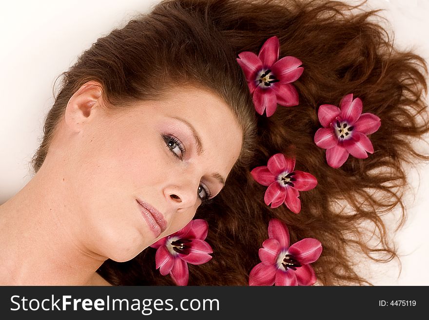 A woman with pink flowers in her hair. A woman with pink flowers in her hair