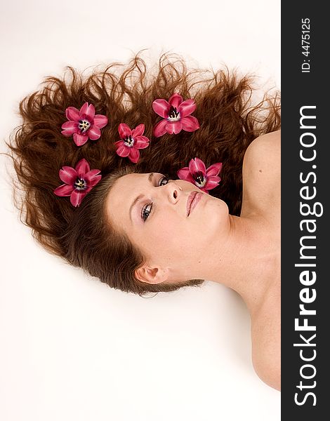A woman with pink flowers in her hair. A woman with pink flowers in her hair