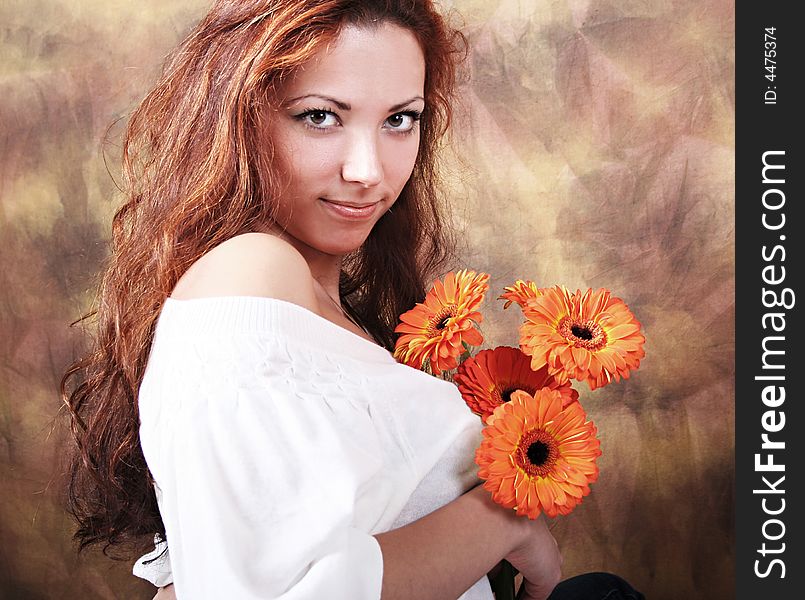 Beautyful young girl with bunch of flowers