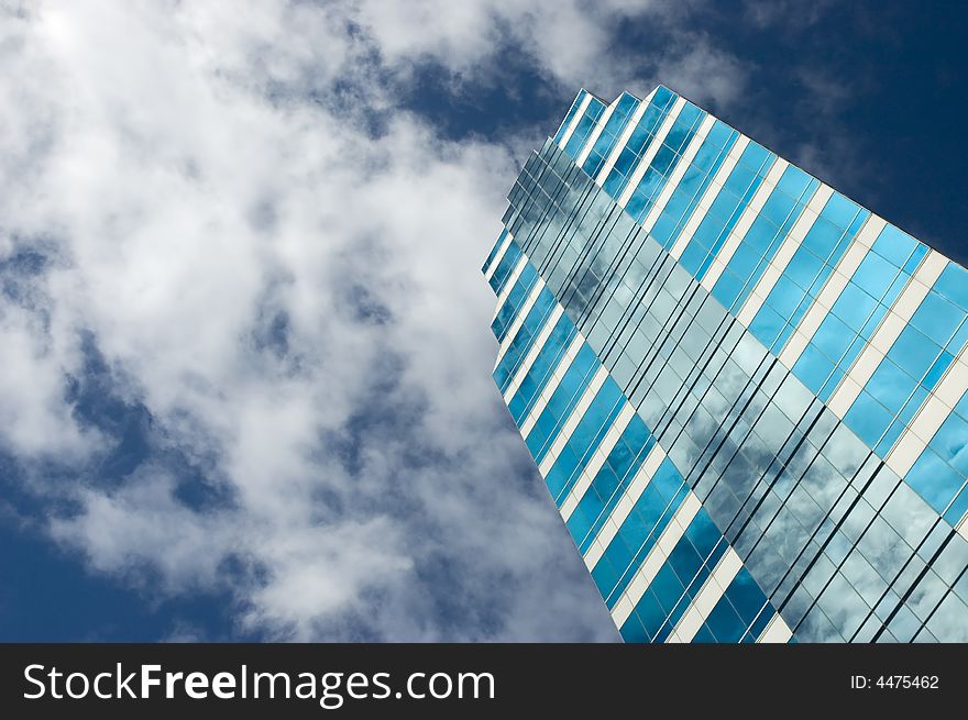 Blue glass office building against blue sky. Blue glass office building against blue sky