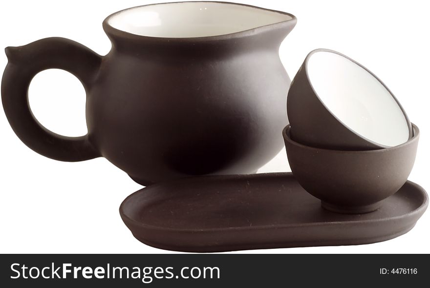 Isolated brown teapot and the cup against a white background. Isolated brown teapot and the cup against a white background