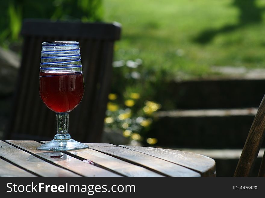 A glass of wine on a summers day in a garden