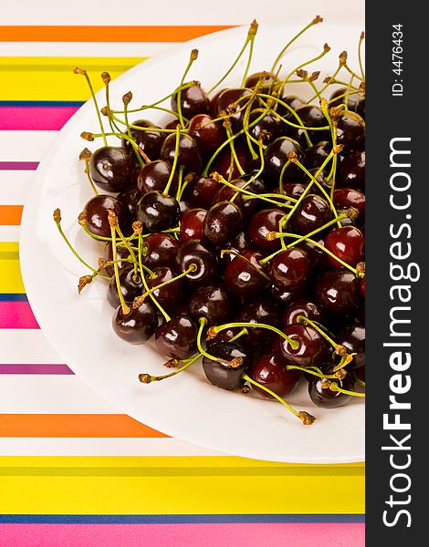 Food series: tasty fresh red cherry on the plate. Food series: tasty fresh red cherry on the plate