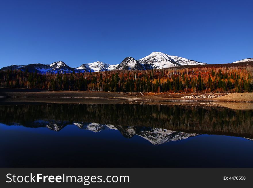 High mountain lake in the fall showing autumn colors reflected in the water. High mountain lake in the fall showing autumn colors reflected in the water