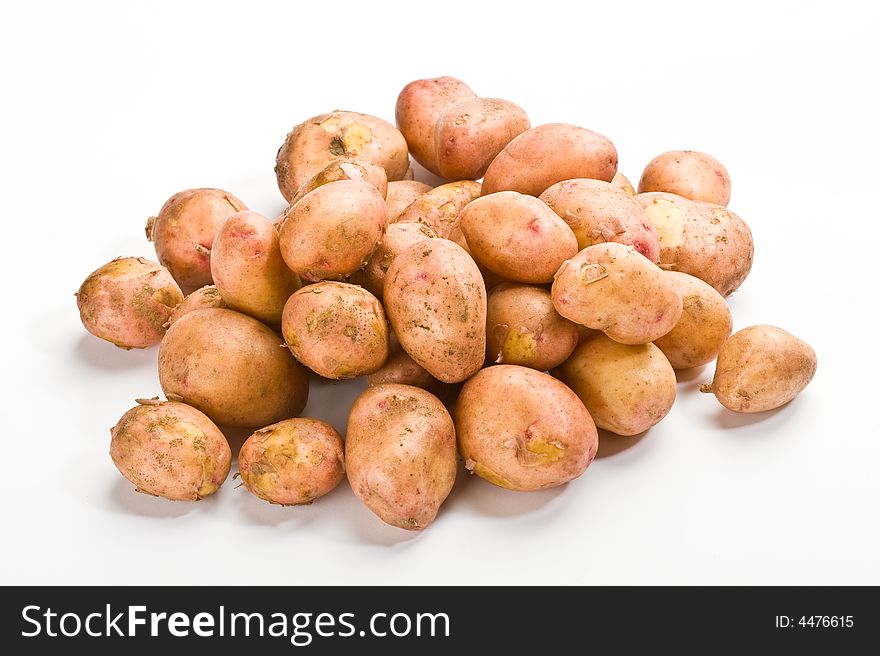 Hill of new potatoes over white background