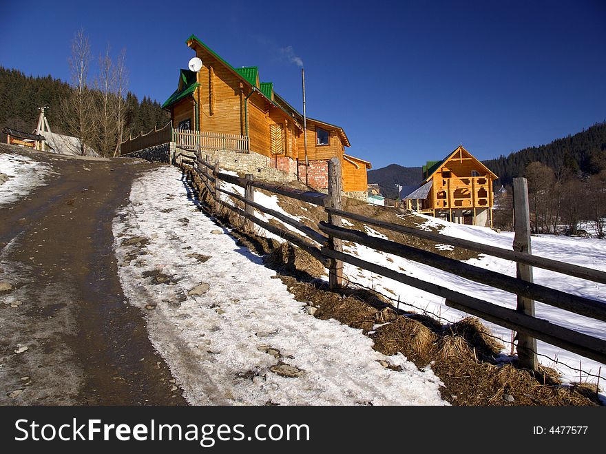 Small wooden houses in a hilly terrain. Small wooden houses in a hilly terrain