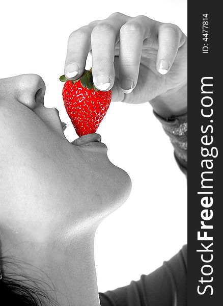 A girl eating a strawberry