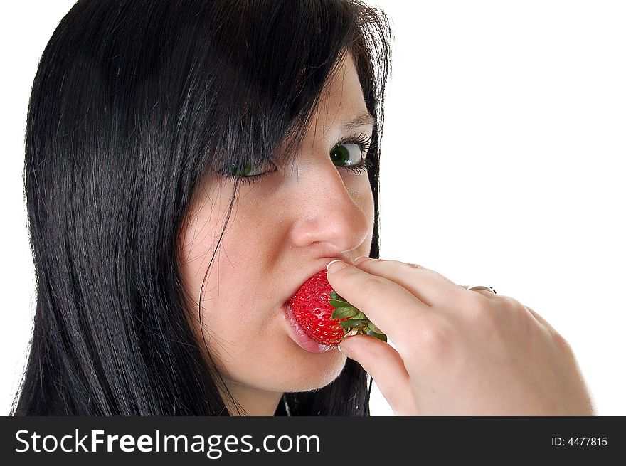 A girl eating a strawberry