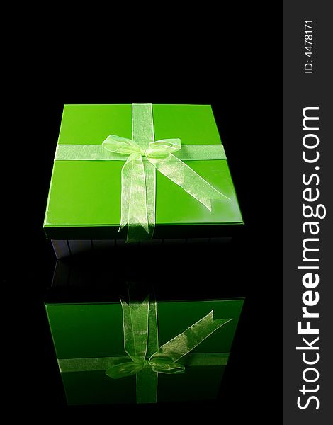 A green gift box with reflex