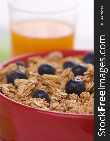 Bowl of Granola Cereal with Blueberries and Juice. Bowl of Granola Cereal with Blueberries and Juice