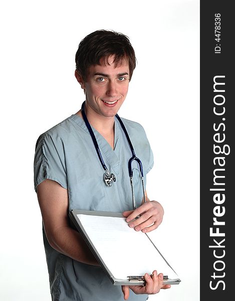 Young dark haired male medical intern with green scrubs and stethoscope and clipborad big smile slight turn. Young dark haired male medical intern with green scrubs and stethoscope and clipborad big smile slight turn