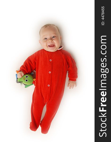 A baby in red with a toy