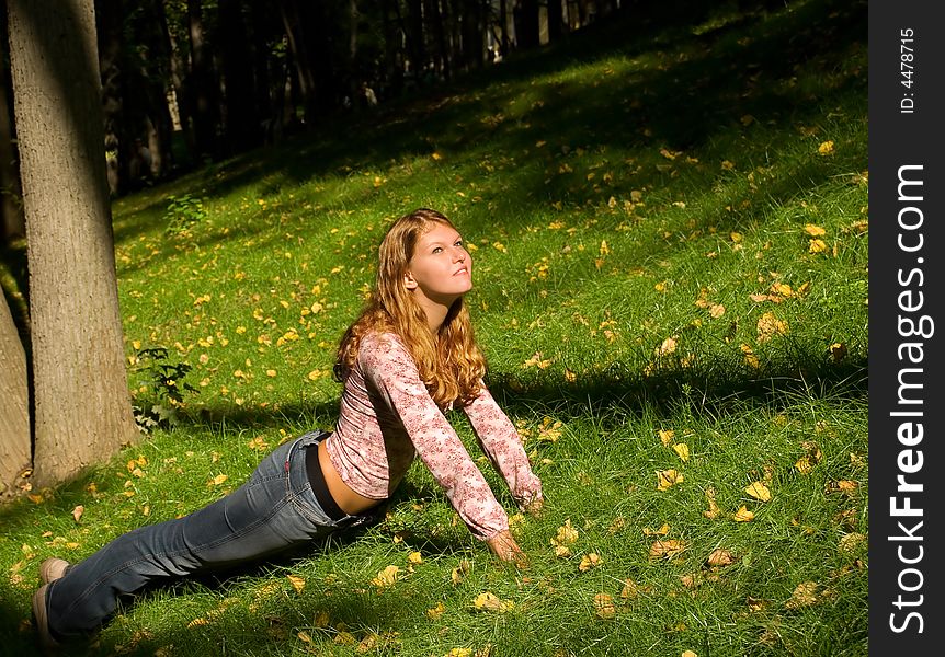 Pretty girl doing exercises on the grass. Pretty girl doing exercises on the grass