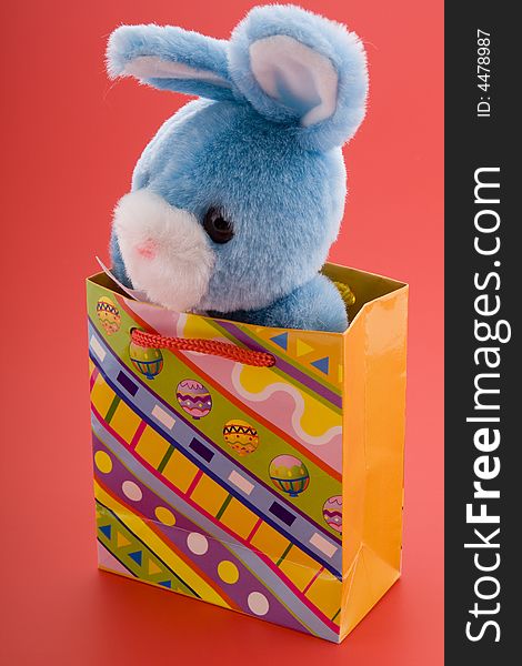 Blue plush bunny in an Easter decoration. Blue plush bunny in an Easter decoration