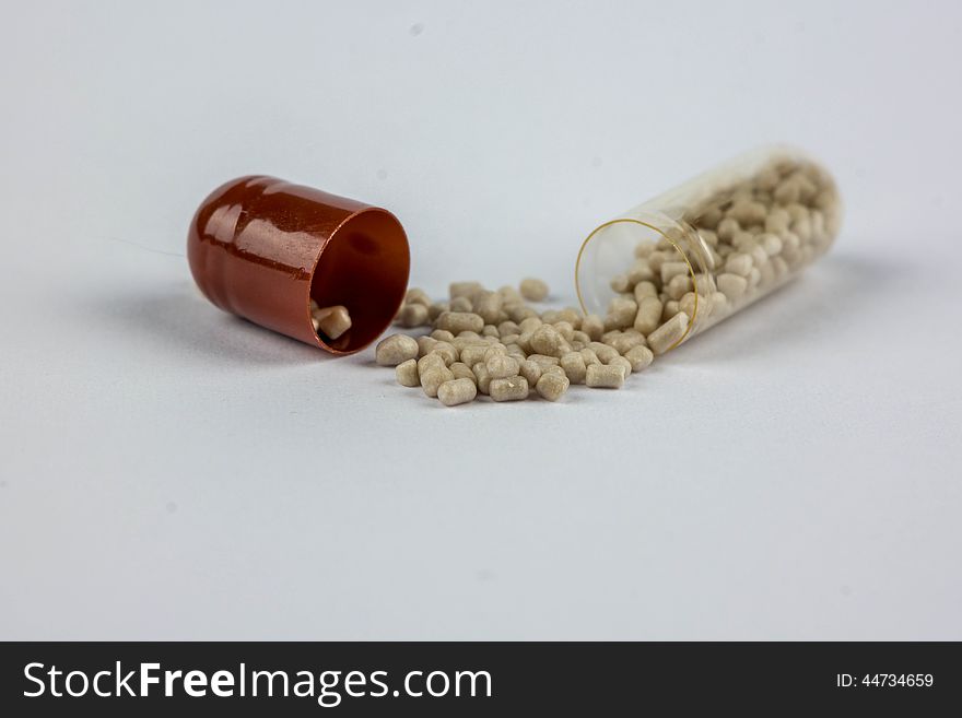 Open capsule with small beads are scattered drugs