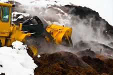 Action Shot Of Front-end Loader And Mulch Piles Royalty Free Stock Photo