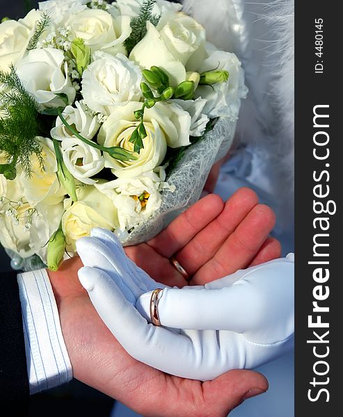 Two hands with rings and flowers