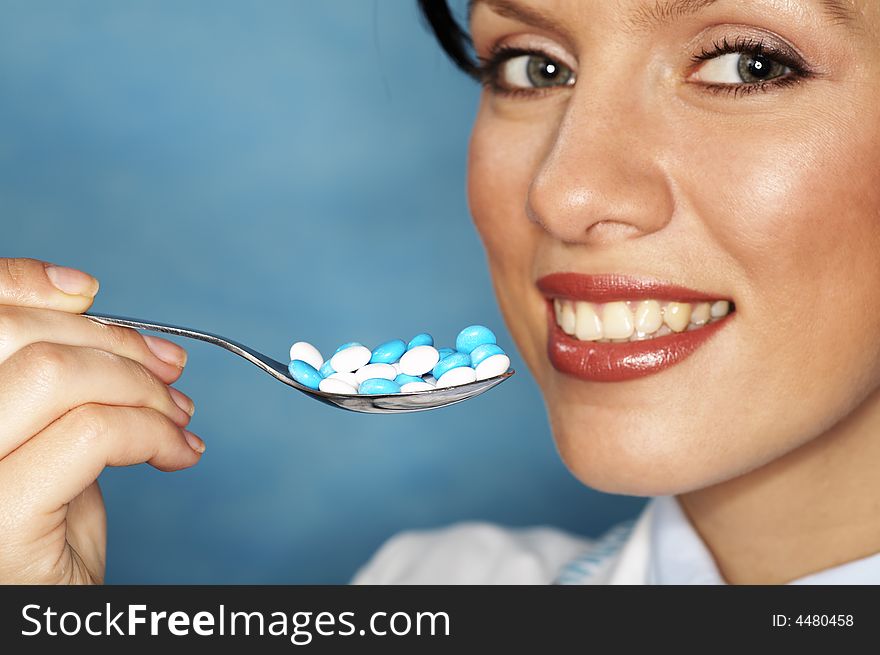 Beautiful caucasian doctor with white/blue pills. Beautiful caucasian doctor with white/blue pills