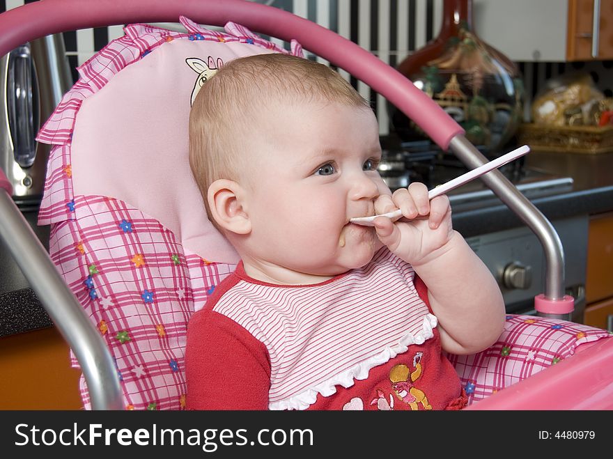 Portrait of a child from is spoon in  mouth. Portrait of a child from is spoon in  mouth