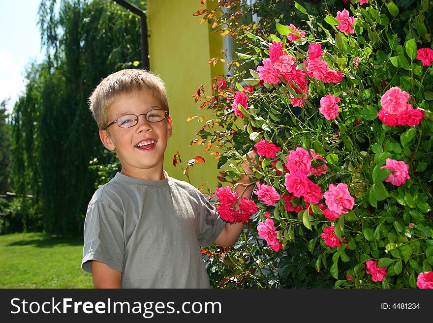 Boy with roses in summer time