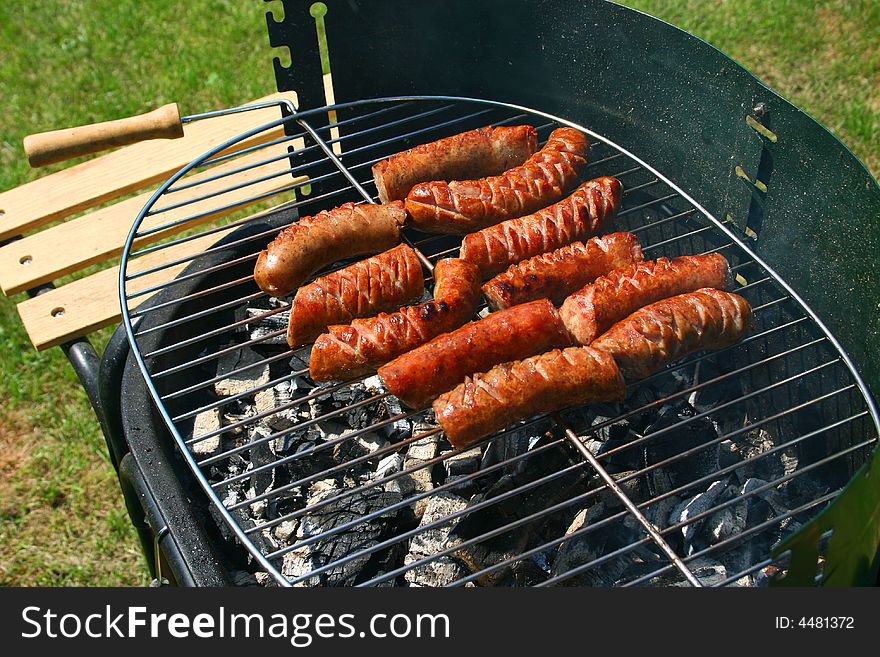 Sausages cooking on the grill. Sausages cooking on the grill