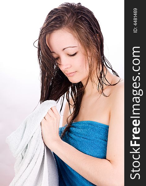 Young woman thinking with a towel in her hand. Young woman thinking with a towel in her hand