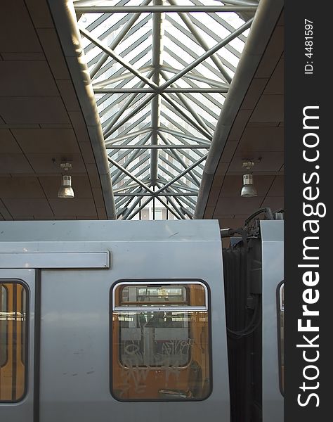 Detail of a metro train with a silhouette of a metro station roof