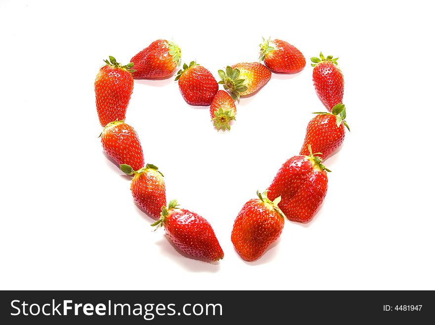 Few strawberries in a shape of heart on white background. Few strawberries in a shape of heart on white background